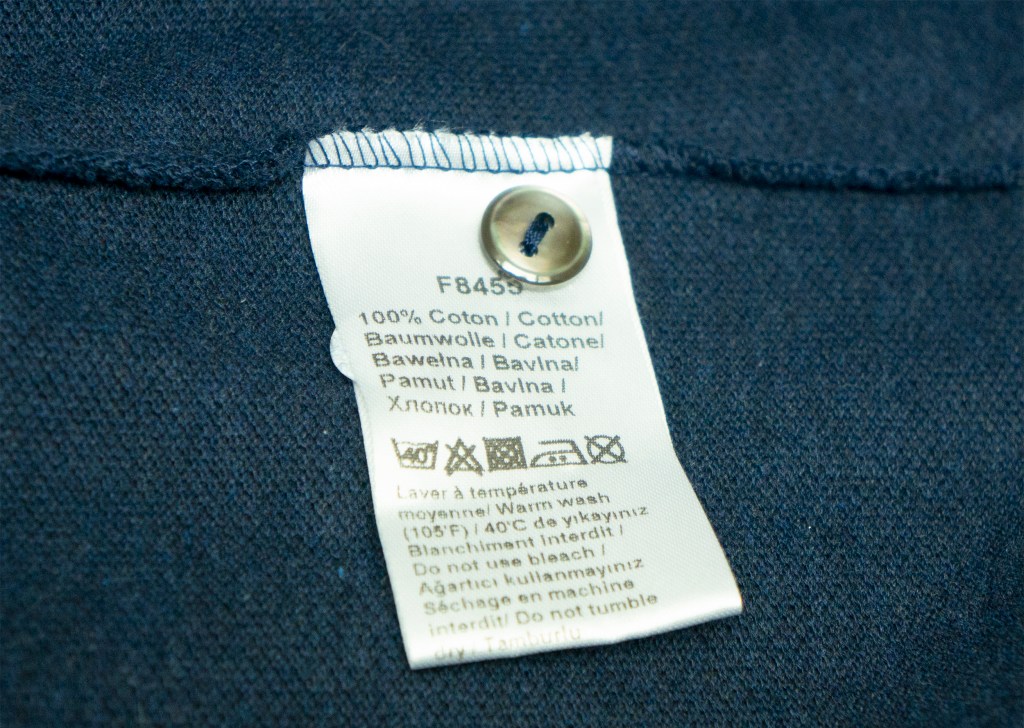 Tag with a button on the original Lacoste